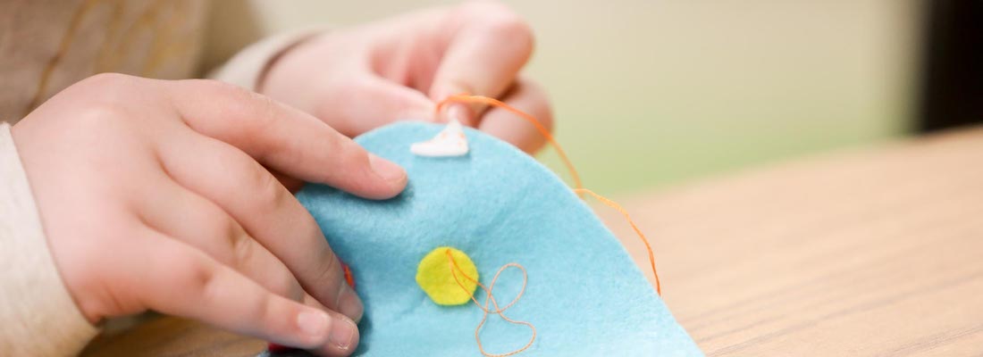 Student's hands sewing