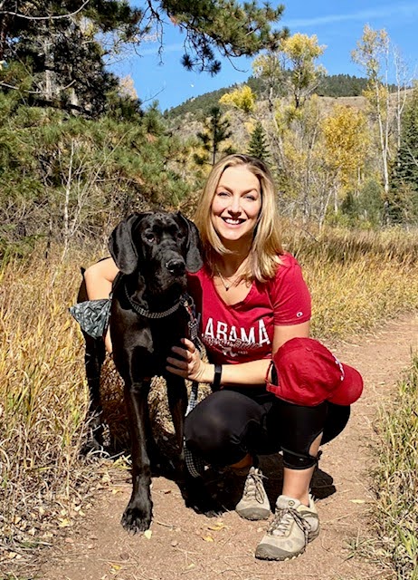 Ms. B with dog on a mountain hiking trail