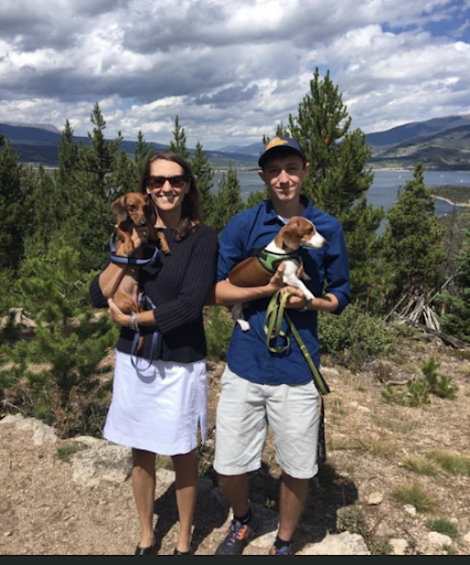 Picture of Ms Amy with her dogs on a mountain